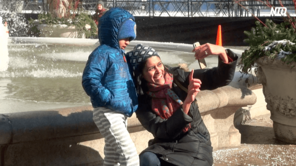Neil celebrates his fifth birthday with his mother, Vnithya at the frozen fountain at the Bryant Park on the morning of Jan. 31. (Shelbi Malonson/The Epoch Times)