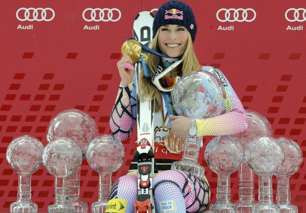 Lindsey Vonn, of the United States, poses in Garmisch-Partenkirchen, Germany, with all the Olympic medals and Women's World Cup trophies she won in her career on March 13, 2010. (Giovanni Auletta/AP Photo)