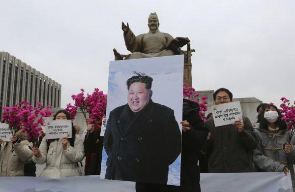 South Korean college students stand with a portrait of North Korean leader Kim Jong Un during a rally to welcome his possible visit to South Korea, in Seoul, South Korea, Thursday, Jan. 31, 2019. (Ahn Young-joon/AP Photo)