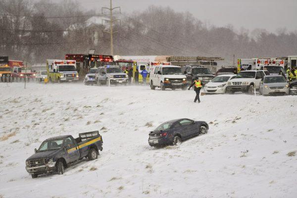Emergency responders help victims from their cars after a multicar pileup, in Wyomissing, Pa., on Jan. 30, 2019. (Lauren A. Little/Reading Eagle via AP)