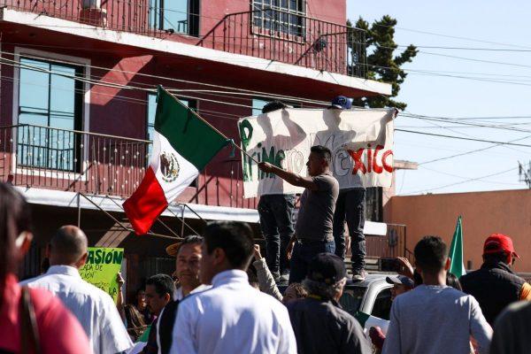 Mexicans protest the migrant caravan from Central America as riot police keep them away from the migrant encampment in Tijuana, Mexico, on Nov. 18, 2018. (Charlotte Cuthbertson/The Epoch Times)