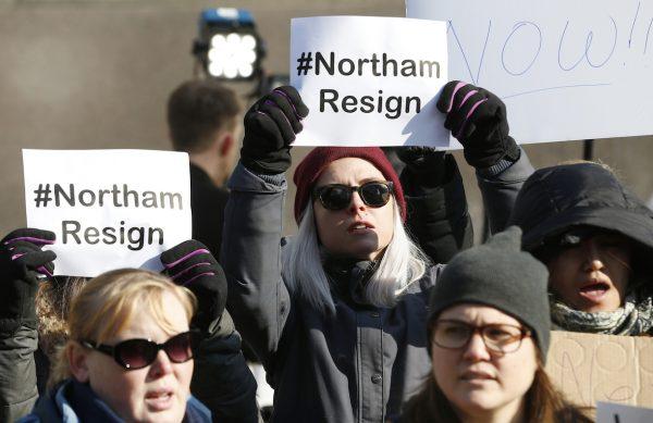 Demonstrators hold signs and chant outside the Governor's Mansion at the Capitol in Richmond, Va., on Feb. 2, 2019. The demonstrators are calling for the resignation of Virginia Gov. Ralph Northam after a 30-year-old photo of him in his medical school yearbook was widely distributed Feb. 1, 2019. (Steve Helber/AP Photo)