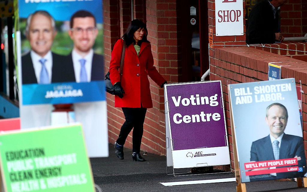 A woman arrives to vote past electoral placards featuring photos of Bill Shorten, Leader of the Australian Labor Party and Malcolm Turnbull, Leader of the Liberal Party of Australia outside of a pre-poll voting centre for the 2016 federal election on June 16, 2016 in Melbourne, Australia. (Scott Barbour/Getty Images)