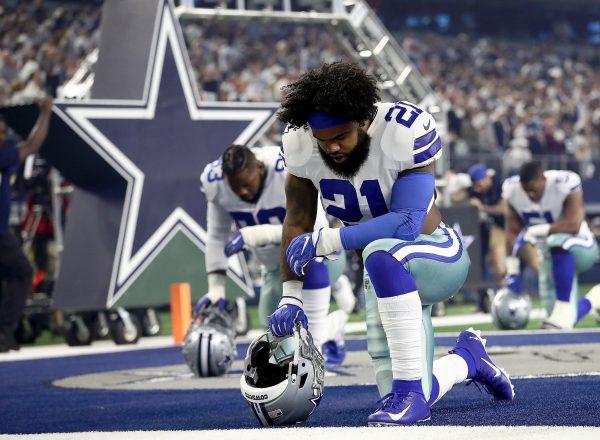 Ezekiel Elliott #21 of the Dallas Cowboys kneels in the end zone before the game against the Seattle Seahawks during the Wild Card Round at AT&T Stadium on Jan. 5, 2019 in Arlington, Texas. (Ronald Martinez/Getty Images)
