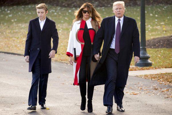 In this Nov. 20, 2018, file photo President Donald Trump accompanied by first lady Melania Trump, and their son Barron, left, walks towards Marine One on the South Lawn of the White House in Washington. (AP Photo/Andrew Harnik, File)