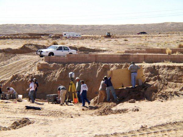 Forensic experts excavate human remains from an area that had been razed for a housing development in Albuquerque, N.M., on Feb. 28, 2009. (Susan Montoya Bryan/AP Photo)