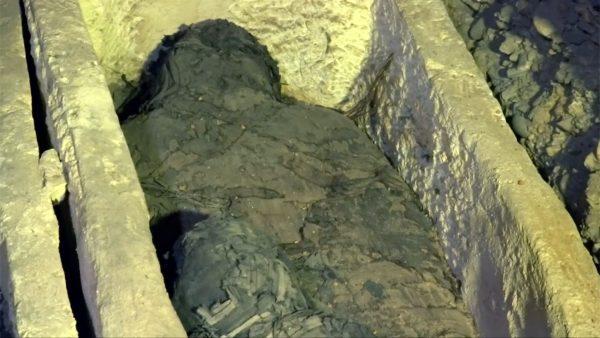 Wrapped mummy inside burial site in Tuna El-gebel Region, Minya, Egypt, on Feb. 2, 2019. (Screenshot/Reuters)