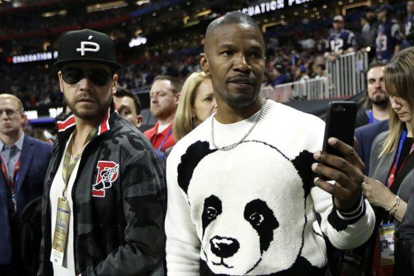 Actor Jamie Foxx, right, watches the teams warm up, before the NFL Super Bowl 53 football game between the Los Angeles Rams and the New England Patriots in Atlanta, on Feb. 3, 2019. (Mark Humphrey/AP)