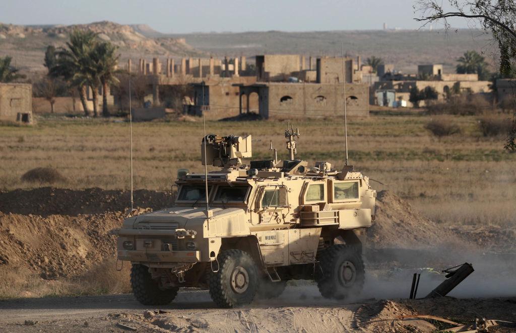 A US military vehicle drives through the Syrian village of Baghuz in the countryside of the eastern Deir Ezzor province on Jan. 26, 2019. (Delil Souleiman/AFP/Getty Images)