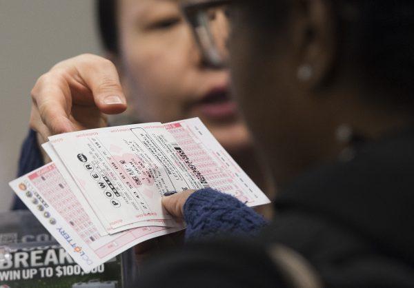 A woman purchases a Powerball lottery ticket at a convenience store in Washington, DC, Jan. 7, 2016. (Saul Loeb/AFP/Getty Images)
