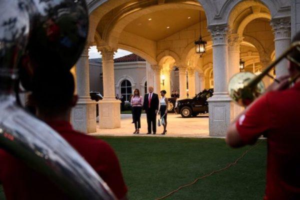 President Donald Trump and First Lady Melania Trump listen to the Florida Atlantic University band at the Trump International Golf Club before a Super Bowl party in West Palm Beach, Fla., on Feb. 3, 2019. (Brandan Smialowski/AFP/Getty Images)