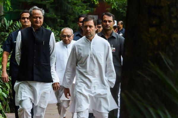 President of the Indian National Congress Party Rahul Gandhi (R) talks with Congress party's national general secretary Ashok Gehlot (L) and party member Motilal Vora (C) at the All India Congress Committee offices where Gandhi met the Congress Working Committee in New Delhi on Aug. 4, 2018. (Chandon Khanna/AFP/Getty Images)