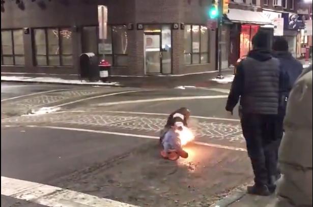 A man rolls on the ground with flames on his pants after being tased on Feb. 1 outside a Steak Restaurant in Philadelphia. (Storyful/Pat Tackney)