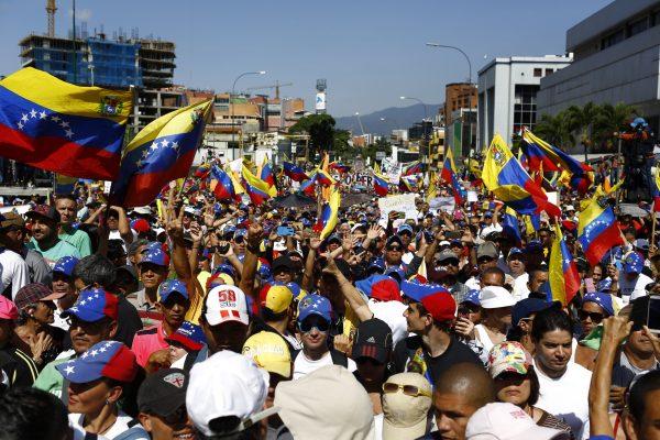People attend a rally against the government of Nicolás Maduro in the streets of Caracas, on Feb. 2, 2019, in Caracas, Venezuela. Venezuela's self-declared president and accepted by over 20 countries, Juan Guaido, called Venezuelans to the streets and demand the resignation of Nicolás Maduro. (Marco Bello/Getty Images)