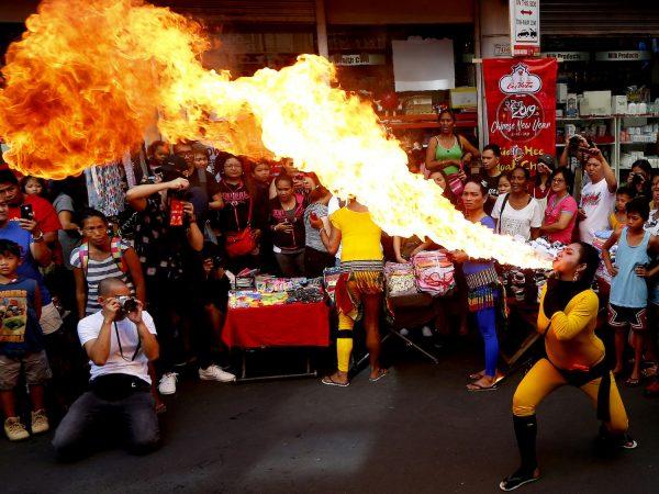 A fire-eater performs during celebrations of the Lunar New Year at Manila's Chinatown district in Manila, Philippines on Feb. 5, 2019. (AP Photo/Bullit Marquez)