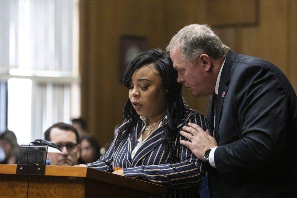 Kalamazoo County Prosecutor, Jeff Getting, whispers in the ear of Tiana Carruthers as she addresses Jason Dalton before he is sentenced to life in prison without possibility of parole for six counts of murder and several other charges at the Kalamazoo County Courthouse in Kalamazoo, Mich., on Feb. 5, 2019. (Joel Bissell/MLive.com)