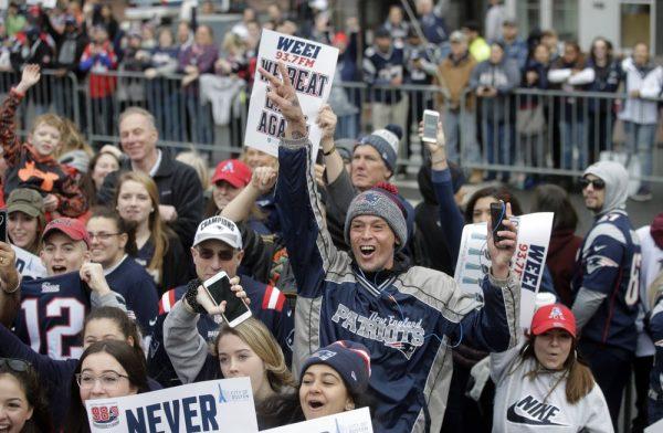 Fans wait for the New England Patriots parade to through downtown Boston to celebrate their win over the Los Angeles Rams in Sunday's NFL Super Bowl 53 football game in Atlanta, on Feb. 5, 2019. (Steven Senne/AP Photo)