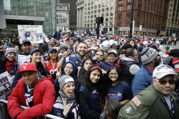Fans gather near Boston City Hall to watch the New England Patriots football team victory parade through the streets of Boston to celebrate their win over the Los Angeles Rams for their sixth NFL Super Bowl championship on Feb. 5, 2019. (AP Photo/Elise Amendola)