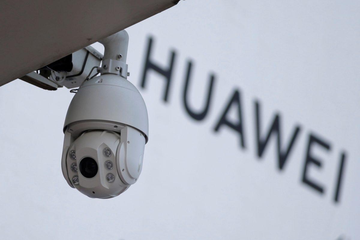 A surveillance camera is seen next to a sign of Huawei outside a shopping mall in Beijing on Jan. 29, 2019. (Jason Lee/Reuters)