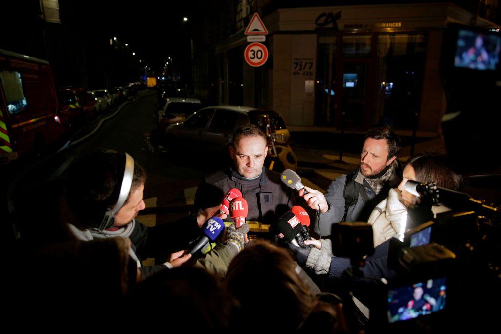 Fire service spokesman Clement Cognon speaks to the press after a building caught fire in the 16th arrondissement in Paris, on Feb. 5, 2019. (Geoffroy Van Der Hasselt/AFP/Getty Images)