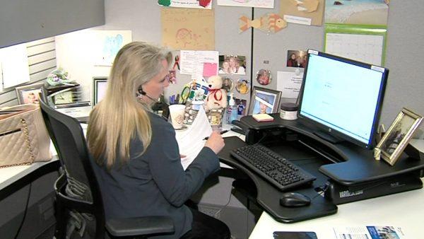 An employee sitting long hours in front of computer, which is likely to bring health issue among U.S. adults. (image via Fox News)