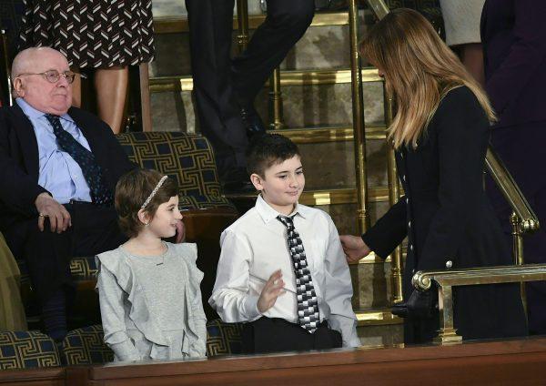 First Lady Melania Trump (R) greets Grace Eline and Joshua Trump, special guests of the president, before President Donald Trump's State of the Union address at the Capitol on Feb. 5, 2019. (MANDEL NGAN/AFP/Getty Images)