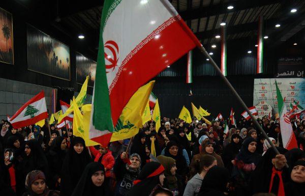 Supporters of Lebanon's Shiite movement Hezbollah wave national, Iranian as well as the movement's yellow flag during celebrations marking the 40th anniversary of the Iranian revolution in the capital Beirut's southern suburbs on Feb. 6, 2019. (Anwar Amro/AFP/Getty Images)