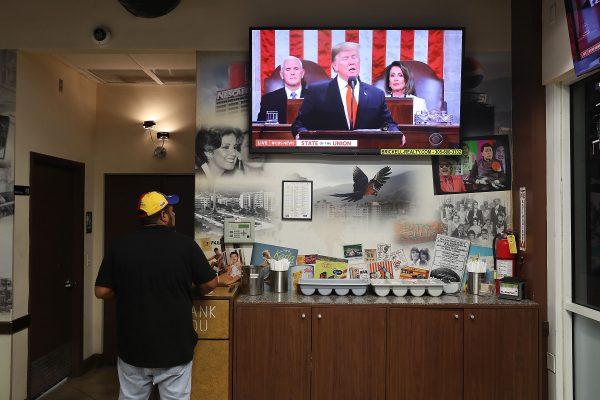 A worker in a restaurant in Doral, Florida, watches President Donald Trump as he delivers his State of the Union address to a joint session of the U.S. Congress on Capitol Hill on Feb. 5, 2019. (Joe Raedle/Getty Images)