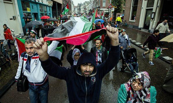 People hold a giant Palestinian flag during a demonstration against Israel's military operations in Gaza and in support of the Palestinian people in the center of Utrecht, on Aug. 17, 2014. (Bart Maat/Getty Images)