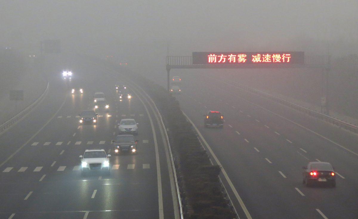 Vehicles along a highway in Beijing on March 17, 2012. Air pollution made travel difficult in China during the lunar new year holidays. (STR/AFP/Getty Images)