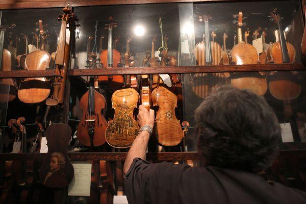 Israeli violin maker Amnon Weinstein shows his violin collection at his workshop in Tel Aviv on July 15, 2016. (Menahem Kahana/AFP/Getty Images