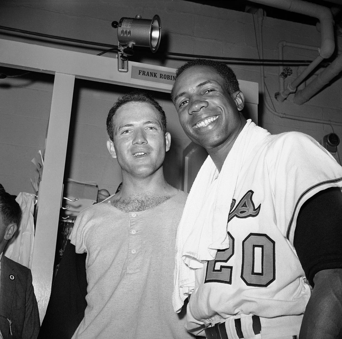 Pitcher Dave McNally, left, and right fielder Frank Robinson pose in the dressing room after the Orioles defeated the Los Angeles Dodgers to win the World Series, in Baltimore. (AP)
