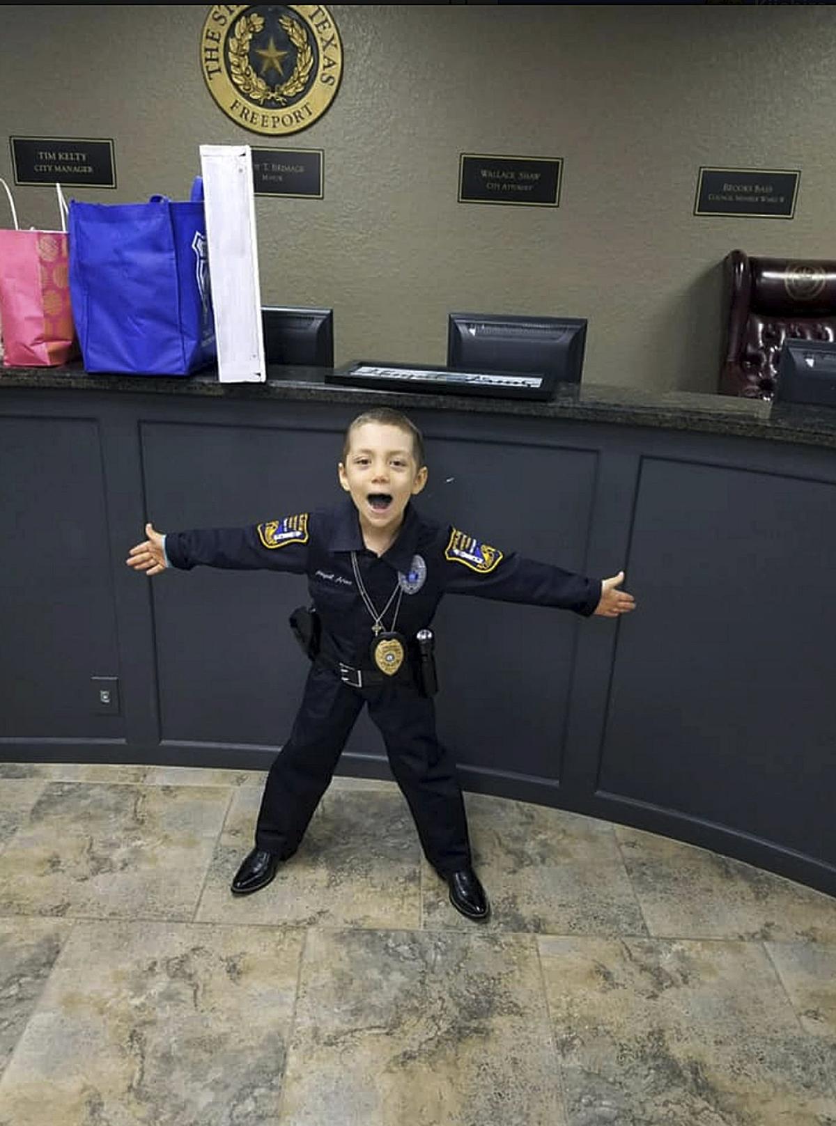 In this Feb. 7, 2019 photo provided by Freeport Police Department, 6-year-old Abigail Arias, who is battling cancer, poses for a picture after being sworn in as a Texas police officer by Freeport Police Chief Ray Garivey in Freeport, Texas. (Freeport Police Department via AP)