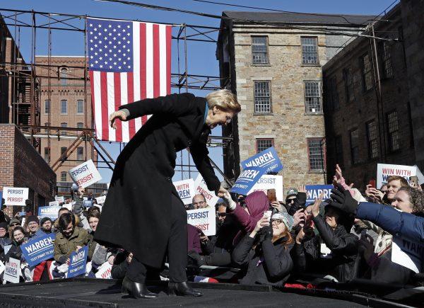 Sen. Elizabeth Warren (D-Mass.) with supporters as she takes the stage during an event to formally launch her presidential campaign in Lawrence, Mass., on Feb. 9, 2019. (Elise Amendola/AP Photo)