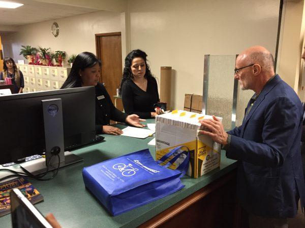 The opponents' attorney Frank Angel, right, hand over the signatures to officials at the El Monte City Clerk's office. (Zach Li/The Epoch Times)