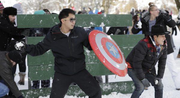 People taking part in a public snowball fight stand in front of a picnic-table shield at Wright Park in Tacoma, Wash., on Feb. 9, 2019. (Ted S. Warren/AP Photo)