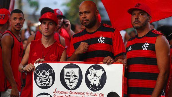 Soccer fans of Flamengo soccer club hold a banner in front of the club's headquarters after a deadly fire in their training center, in Rio de Janeiro, Brazil, on Feb. 9, 2019. (Pilar Olivares/Reuters)
