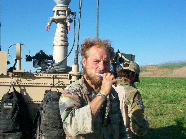 Staff Sergeant Kevin Flike brushing his teeth during his second deployment to Kunduz, Afghanistan 2010. (Courtesy of Kevin Flike)