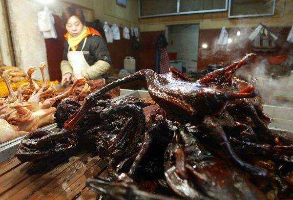 Cooked ducks and chickens are pictured on sale at a market stall in Beijing on Jan. 30, 2004. (Frederic J. Brown/AFP/Getty Images)