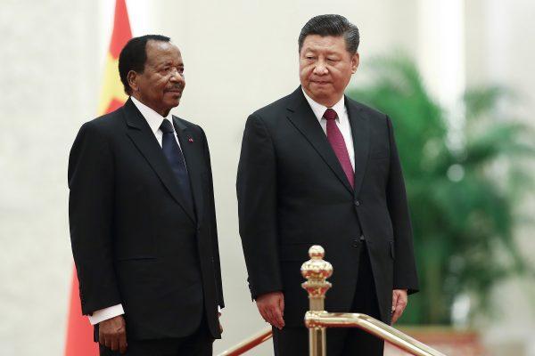 Chinese leader Xi Jinping (R) welcomed President of Cameroon Paul Biya (L) in Beijing on March 22, 2018. The Chinese regime had written off Cameroon's $78 million debts but didn't publicly report it. Media analyzed that the CCP may fear people knowing this happened. (Lintao Zhang/Getty Images)