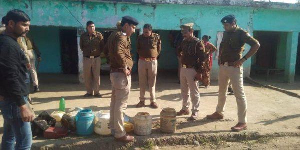 Police in Haridwar, India, stand by some containers of illegal alcohol. (Haridwar Police)