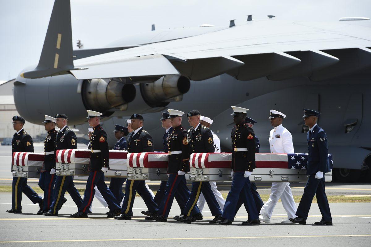 Military pallbearers carry the believed-to-be remains of U.S. service members collected in the Democratic People's Republic of Korea during a repatriation ceremony after arriving to Joint Base Pearl Harbor-Hickam, Honolulu, Hawaii, on Aug. 1 2018. (RONEN ZILBERMAN/AFP/Getty Images)