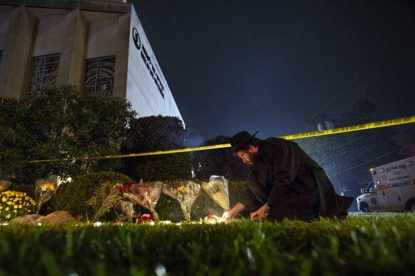 Rabbi Eli Wilansky lights a candle after a mass shooting at Tree of Life Synagogue in Pittsburgh's Squirrel Hill neighborhood, on Oct. 27, 2018. (Steph Chamber/Pittsburgh Post-Gazette via AP)