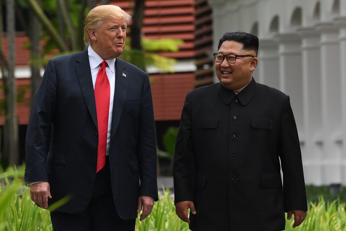 North Korea's leader Kim Jong Un (R) walks with U.S. President Donald Trump during a break in talks at their historic US-North Korea summit, at the Capella Hotel on Sentosa Island in Singapore on June 12, 2018. (SAUL LOEB/AFP/Getty Images)