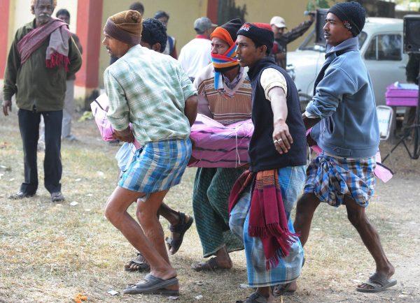 Relatives and hospital staff carry the body of a victim to the mortuary of the Diamond Harbour hospital in Diamond Harbor after dozens died and many injured drinking bootleg liquor in several villages south of Kolkata, on Dec. 15, 2011. (Dibyaangshu Sarkar/AFP/Getty Images)