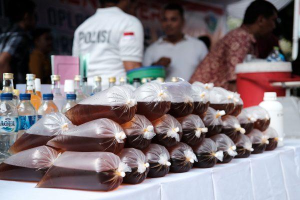 Indonesian police display recently seized bootleg liquor prior to a press conference in Jakarta. (Bagus Saragihi/AFP/Getty Images)
