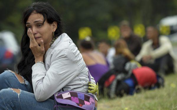 Venezuelan migrant Lulexis Gonzalez cries after stopping on the road from Cucuta to Pamplona, in Norte de Santander Department, Colombia, on Feb. 10, 2019. (Raul Arboleda/AFP/Getty Images)