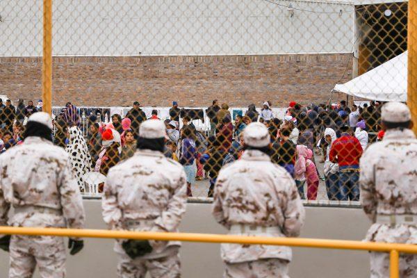 Mexican police and military personnel guard the outside of an old factory where around 1,800 Central American migrants are being held in Piedras Negras, Mexico, on Feb. 8, 2019. The majority of the migrants are hoping to get into the United States and claim asylum. (Charlotte Cuthbertson/The Epoch Times)