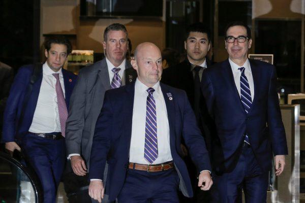 U.S. Treasury Secretary Steven Mnuchin and a member of the U.S. trade delegation to China arrive at a hotel in Beijing on Feb. 13, 2019. (Thomas Peter/Reuters)