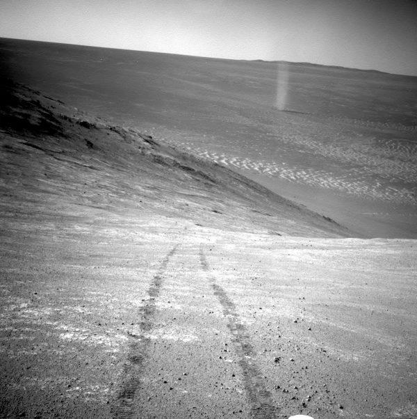 A dust devil in a valley on Mars, seen by the Opportunity rover perched on a ridge on March 31, 2016. (NASA/JPL-Caltech via AP)